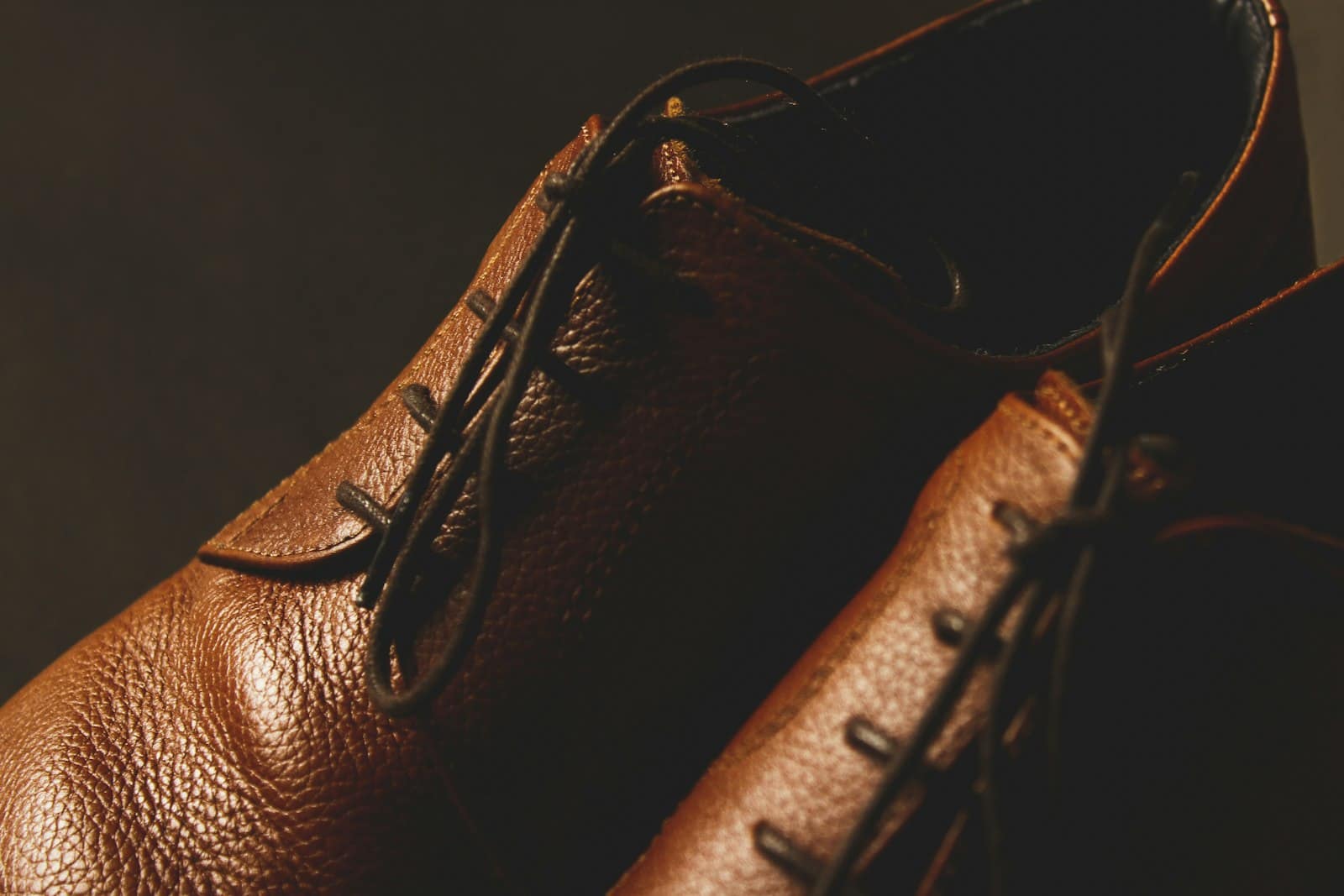 Close-up of brown leather shoes in low, warm light