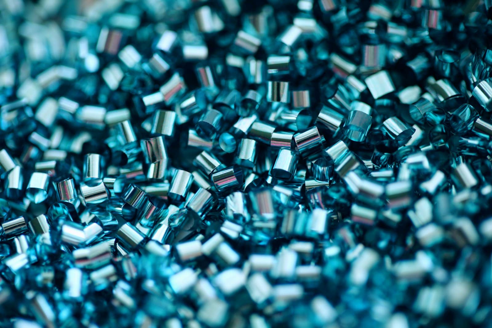 A close view of raw moulding granules heaped together, each pellet catching the light