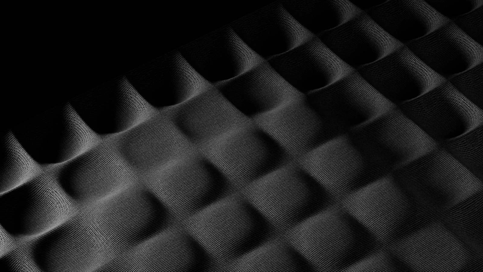 Foamed rubber surface under raking light, every cell throwing its own shadow